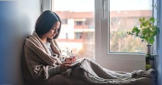 7 Inspirational Word Of The Day Ideas To Uplift You A person writing an inspirational word of the day in a journal to begin the day with positive mindset and intention.